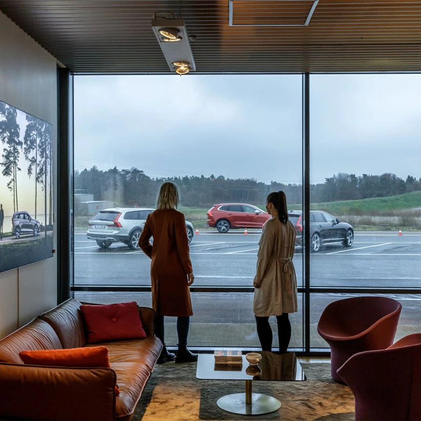 two people looking at cars through the window